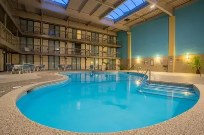 a large pool in the middle of a building at Holiday Inn Harrisburg I-81 Hershey Area by IHG in Grantville