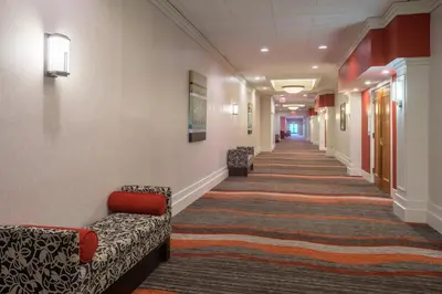 a hallway with couches and chairs in a hospital at Holiday Inn Harrisburg I-81 Hershey Area by IHG in Grantville