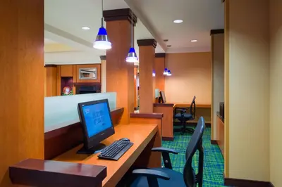 an office with a computer on a desk with chairs at Fairfield Inn & Suites Lock Haven in Lock Haven