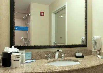 a bathroom with a sink and a large mirror at Hampton Inn North Brunswick NJ in North Brunswick