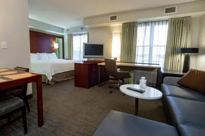 a hotel room with a bed and a living room at Residence Inn by Marriott Hazleton in Hazleton