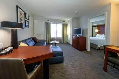 a hotel room with a couch and a bed at Residence Inn by Marriott Hazleton in Hazleton