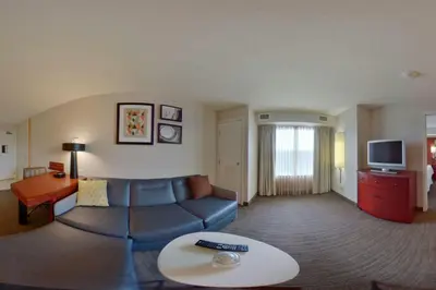 a living room with a couch and a tv at Residence Inn by Marriott Hazleton in Hazleton
