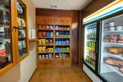a store aisle with an open refrigerator and food at Residence Inn by Marriott Hazleton in Hazleton