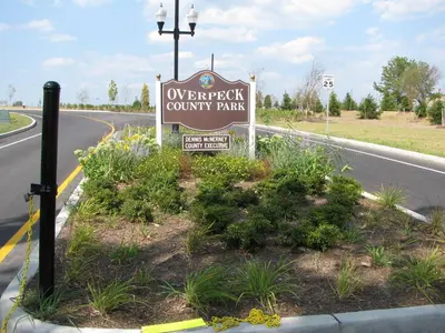 a sign for an overpriced county park on the side of a road at Hilton Garden Inn Ridgefield Park in Ridgefield Park