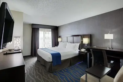 a hotel room with a bed and a television at Holiday Inn Express Hotel & Suites Meadowlands Area by IHG in Carlstadt