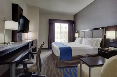 a hotel room with a bed and a desk at Holiday Inn Express Hotel & Suites Meadowlands Area by IHG in Carlstadt