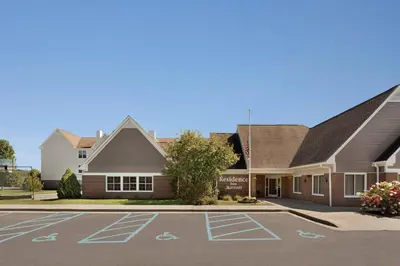 a view of the front of a school with a parking lot at Residence Inn Scranton in Scranton