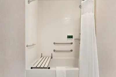 a bathroom with a bath tub with a shower curtain at Residence Inn Scranton in Scranton