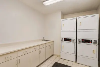 a kitchen with white cabinets and white appliances at Residence Inn Scranton in Scranton