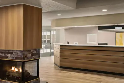 an office lobby with a fireplace in the middle at Residence Inn Scranton in Scranton