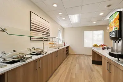 a large kitchen with wooden cabinets and a sink at Residence Inn Scranton in Scranton