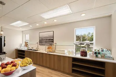 a kitchen with a counter with bowls of fruit on it at Residence Inn Scranton in Scranton