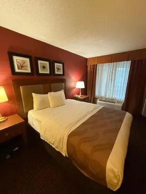 a hotel room with a large bed and a window at Hotel Hanna in Harrisburg