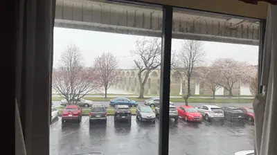 a view of a parking lot with cars parked in the rain at Hotel Hanna in Harrisburg