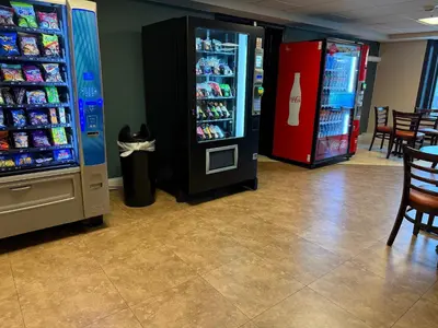 a store with two soda machines and a drink cooler at Hotel Hanna in Harrisburg
