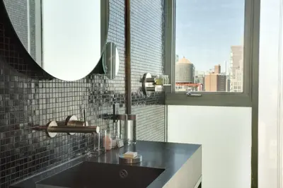 a bathroom with a black sink and a window at Hotel on Rivington in New York