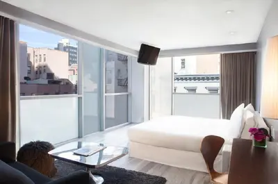a hotel room with a bed and a large window at Hotel on Rivington in New York