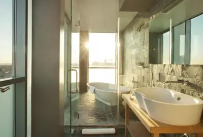 a bathroom with two sinks and two tubs at Hotel on Rivington in New York