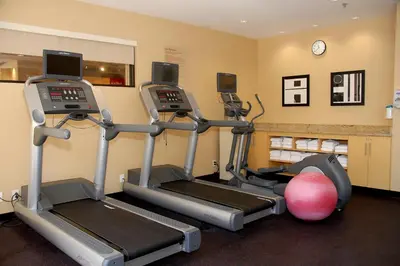 a gym with two tread machines and a ball at TownePlace Suites by Marriott Bethlehem Easton/Lehigh Valley in Hollo