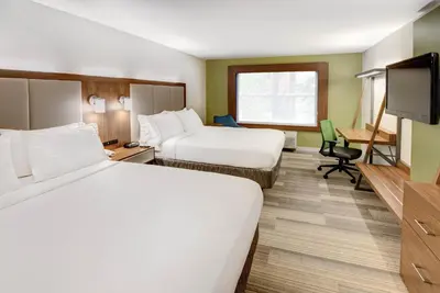 a hotel room with two beds and a television at Holiday Inn Express Woodbridge by IHG in Avenel