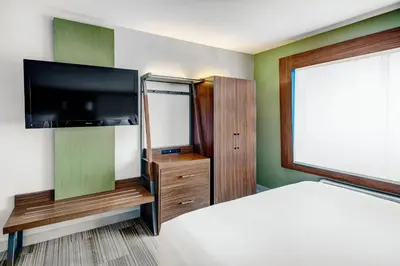 a bedroom with a bed and a flat screen tv at Holiday Inn Express Woodbridge by IHG in Avenel