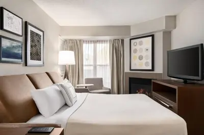 a hotel room with a bed and a flat screen tv at Residence Inn Deptford in Almonesson