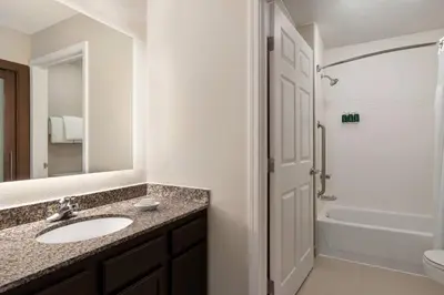 a bathroom with a sink and a toilet and a shower at Residence Inn Deptford in Almonesson