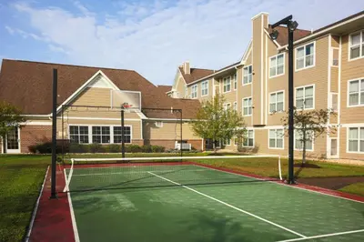 a tennis court in front of a building at Residence Inn Deptford in Almonesson