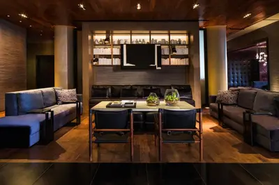 a living room with a table and chairs and a couch at Ink 48 Hotel in New York