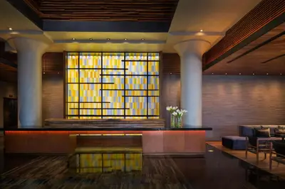 a lobby with a stained glass window and a couch at Ink 48 Hotel in New York