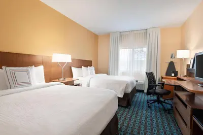 a hotel room with two beds and a television at Fairfield Inn by Marriott Deptford in Deptford