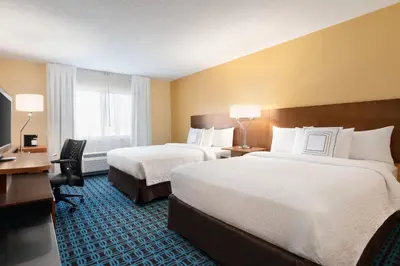 a hotel room with two beds and a desk at Fairfield Inn by Marriott Deptford in Deptford