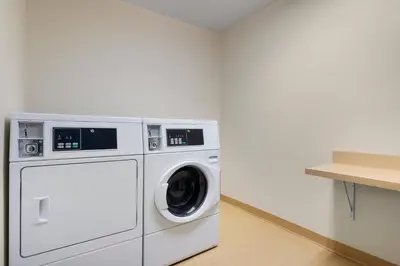 a laundry room with a washer and dryer at Fairfield Inn by Marriott Deptford in Deptford