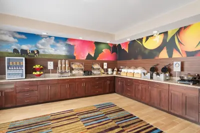 a fast food restaurant with wooden cabinets and colorful walls at Fairfield Inn by Marriott Deptford in Deptford