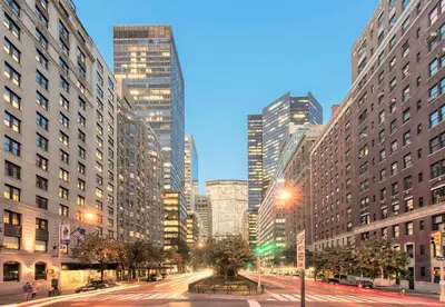 a city street at night with tall buildings at Kimpton Ashbel New York Park Avenue in New York
