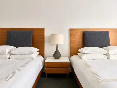 two beds sitting next to each other in a room at Smyth Tribeca in New York