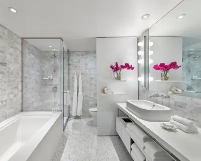 a bathroom with a tub and a sink and a toilet at Smyth Tribeca in New York