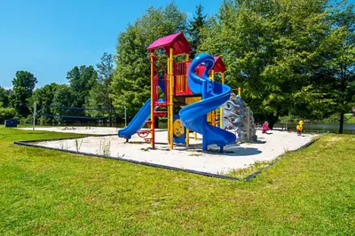 a playground with a slide in a park at Hershey Camping Resort Park Model 6 in Mount Wilson