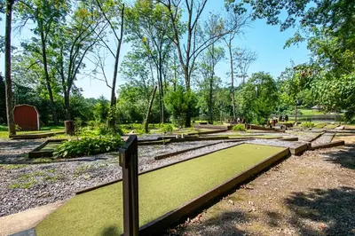 a park with green grass and benches and trees at Hershey Camping Resort Park Model 6 in Mount Wilson
