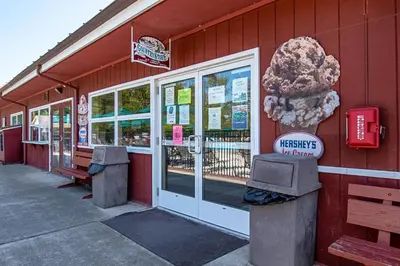 a store with a sign on the side of a building at Hershey Camping Resort Park Model 6 in Mount Wilson