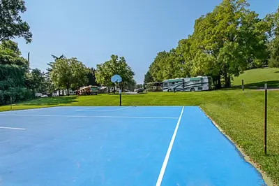 a tennis court with a basketball hoop on it at Hershey Camping Resort Loft Park Model 7 in Mount Wilson