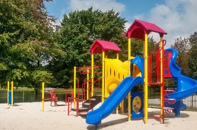 a playground with a slide in the sand at Hershey Camping Resort Loft Park Model 7 in Mount Wilson