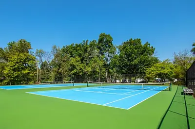 a tennis court with two tennis rackets on it at Hershey Camping Resort Loft Park Model 7 in Mount Wilson