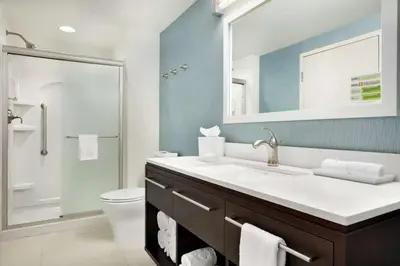 a bathroom with a sink and a toilet and a mirror at Home2 Suites by Hilton Middletown in Middletown