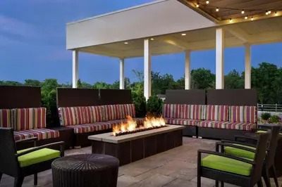 a patio with couches and a fire pit at Home2 Suites by Hilton Middletown in Middletown