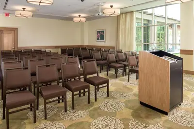 a large room with a row of chairs and a podium at The Inn At Swarthmore in Swarthmore
