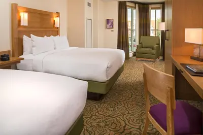a hotel room with two beds and a desk at The Inn At Swarthmore in Swarthmore