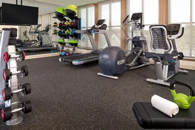 a gym with several treadmills and cardio machines at The Inn At Swarthmore in Swarthmore