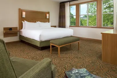 a hotel room with a bed and a chair at The Inn At Swarthmore in Swarthmore